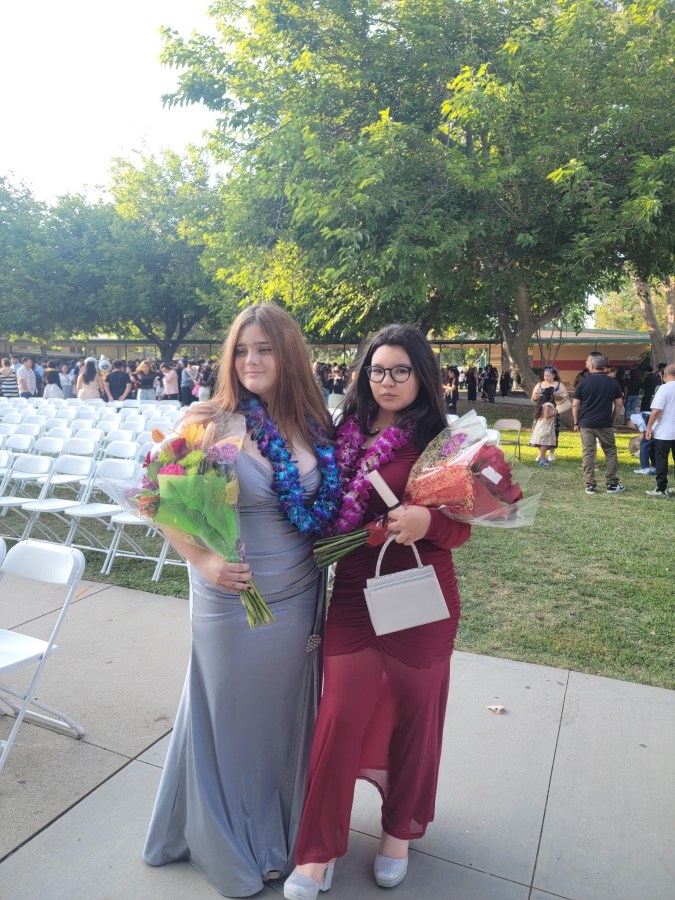 8th grade culmination. Darla in a silver dress. Her friend in maroon. Those leas were soo expensive. 